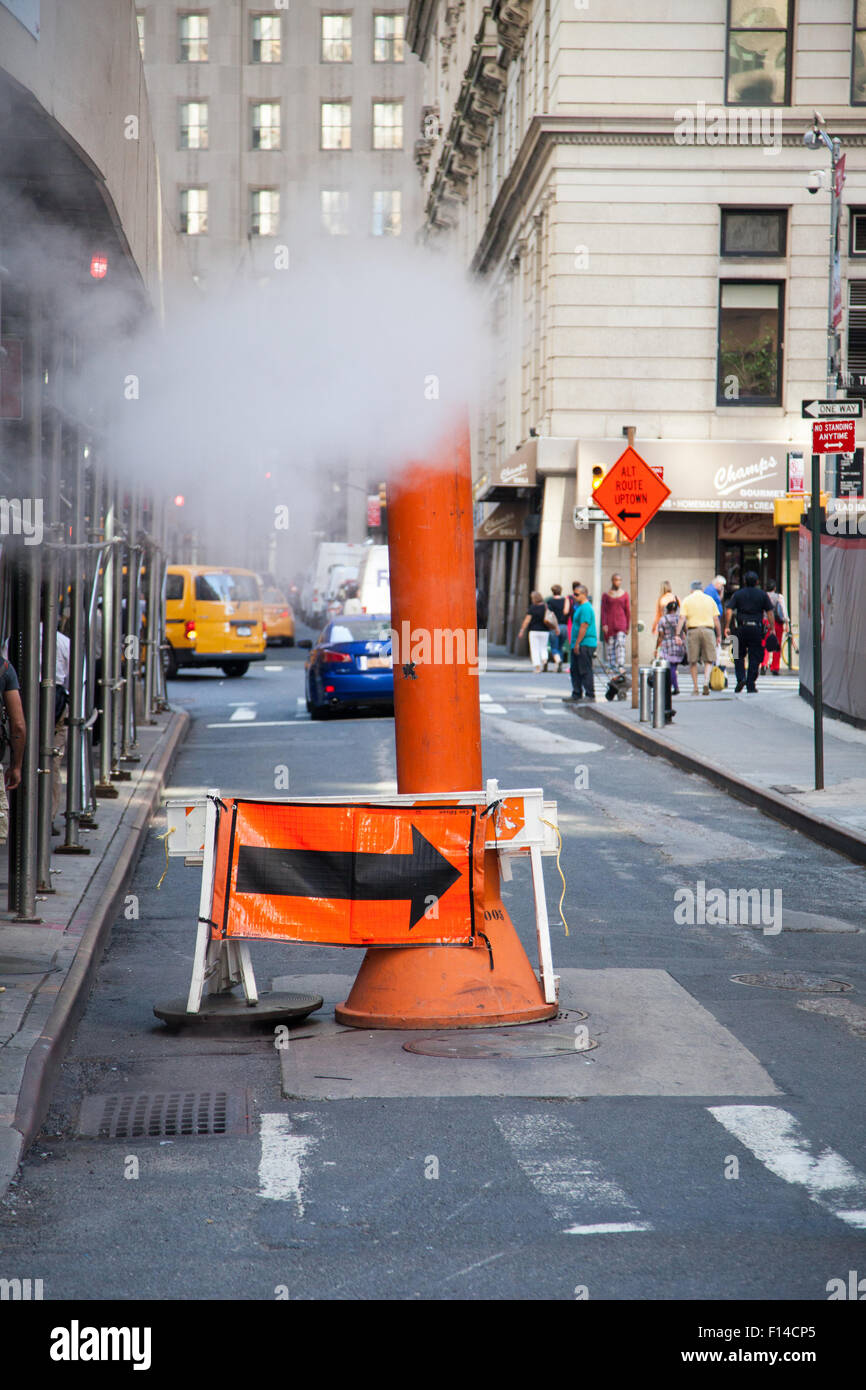 Steam vapor being vented through a typical Con Edison orange stack Stock Photo