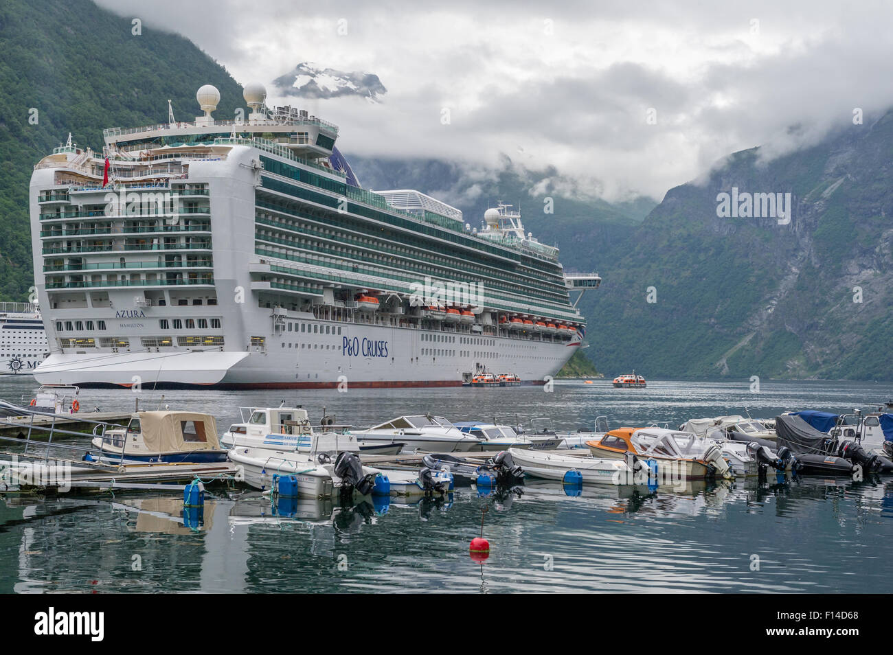 P&O cruise ship Azura tied to the mooring buoys in the Geiranger fjord, Geiranger, Norway Stock Photo