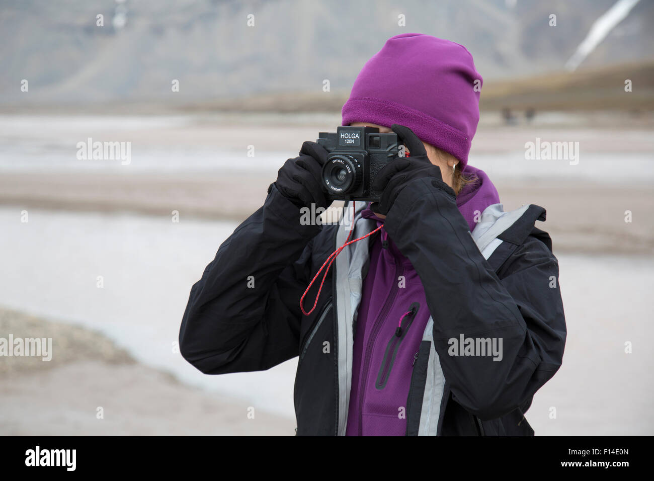 A female photographer using a Holga camera outdoors Stock Photo
