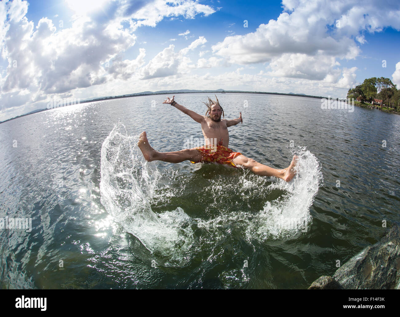 Teenage boy jumping in the river Stock Photo Alamy