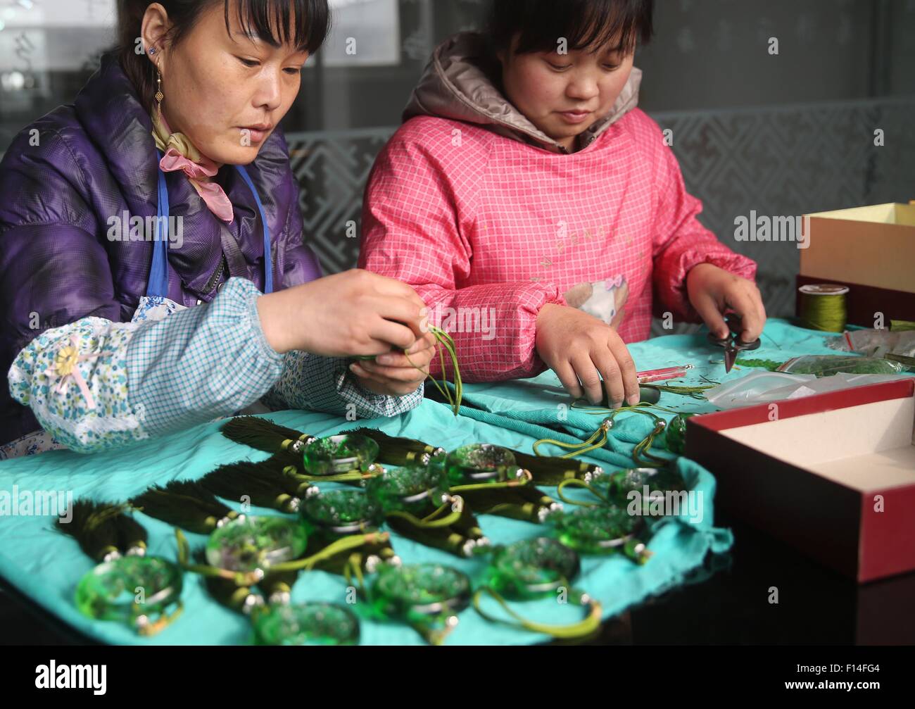 Qinhuangdao, Hebei, CHN. 30th Mar, 2015. Qinhuangdao, CHINA - March 30 2015: (EDITORIAL USE ONLY. CHINA OUT) Coloured glaze is a kind of traditional handicraft, and its raw material is colorful (color is by all kinds of rare metals formation) man-made crystal (including 24% of PbO2), and made from the ancient bronze dewaxing method at high temperature. It's fascinating dazzling. Origin of ancient coloured glaze manufacturing can trace back to the Western Zhou Dynasty, and the initial production of coloured glaze material is obtained as a by-product generated from the bronze casting after re Stock Photo
