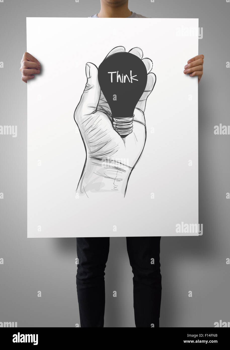Think Hand Drawn man showing poster of Hand drawn light bulb with THINK word on crumpled ...