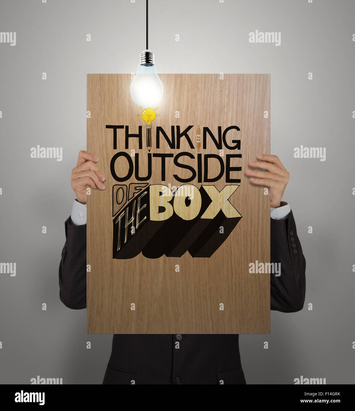 man showing poster of hand drawn word THINKING OUTSIDE OF THE BOX with ...
