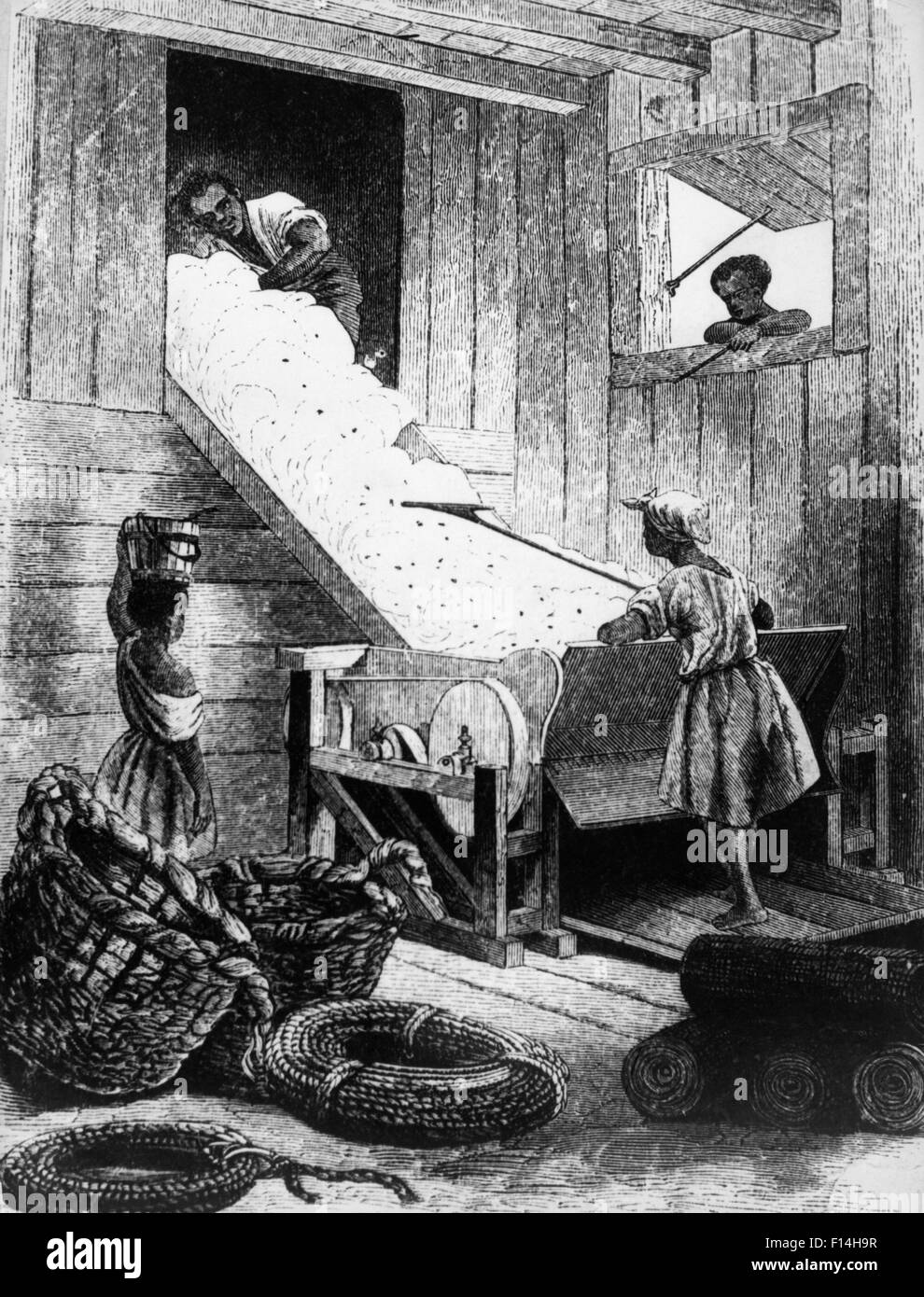 1700s 1800s ILLUSTRATION OF AFRICAN AMERICAN SLAVE WORKERS OPERATING COTTON GIN SOUTHERN USA Stock Photo