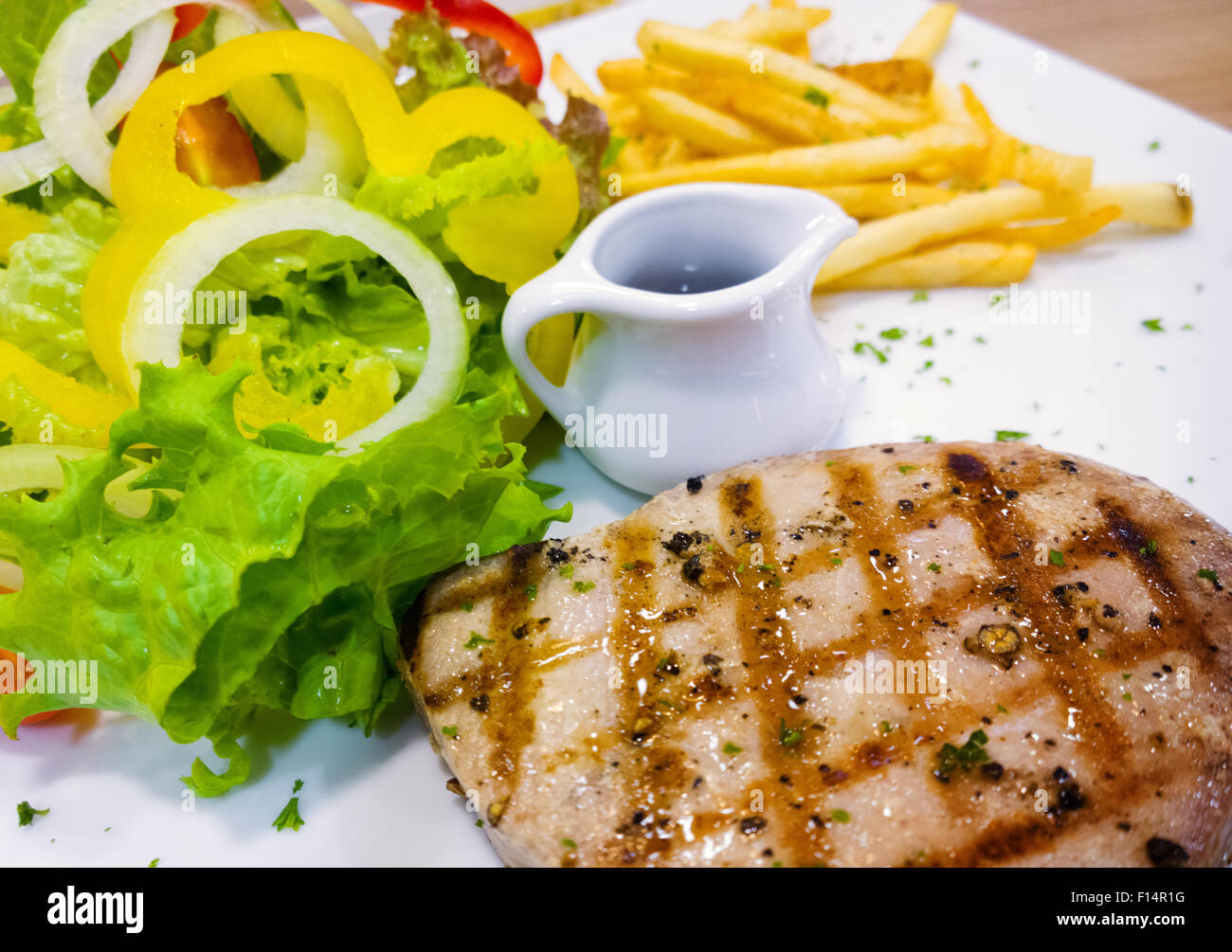 tuna steak, French fries and vegetables Stock Photo Alamy