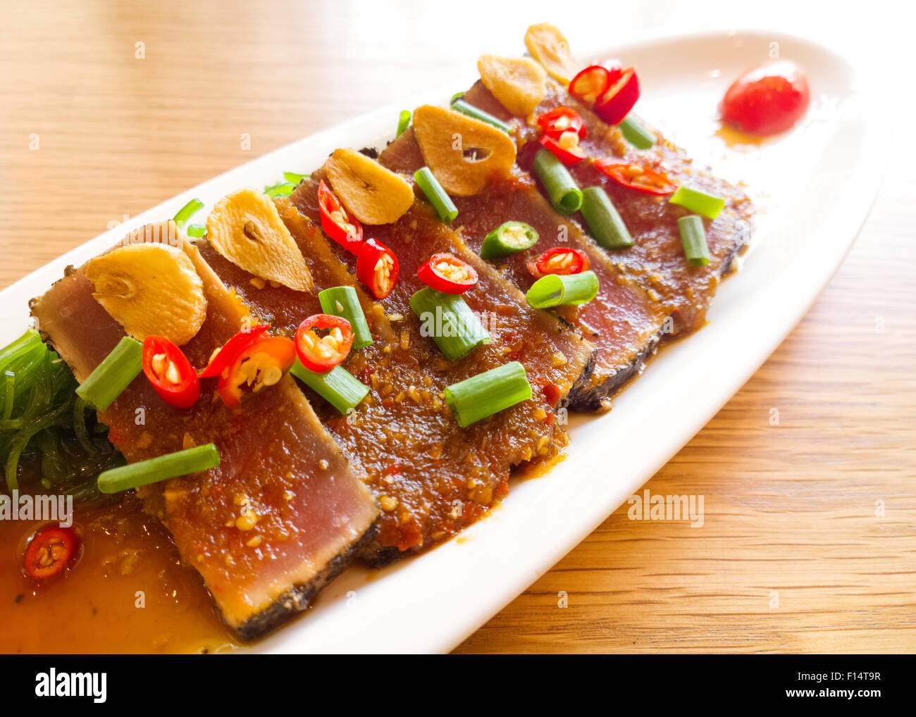 smoke tuna spicy with salad frieze on wooden table Stock Photo