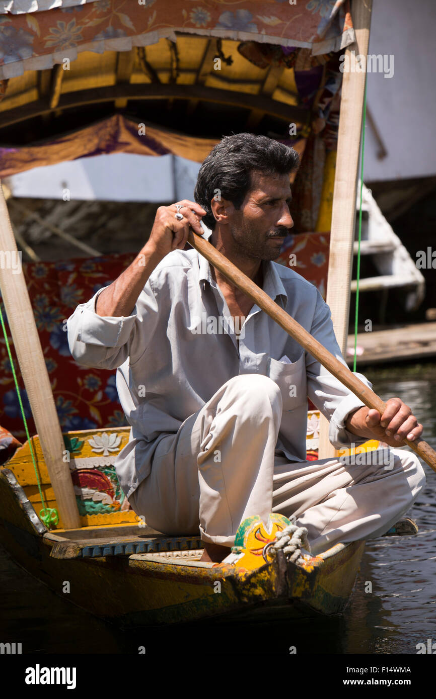 India, Jammu & Kashmir, Srinagar, Dal Lake, Kashmiri shikara wallah, padding at prow of his boat Stock Photo