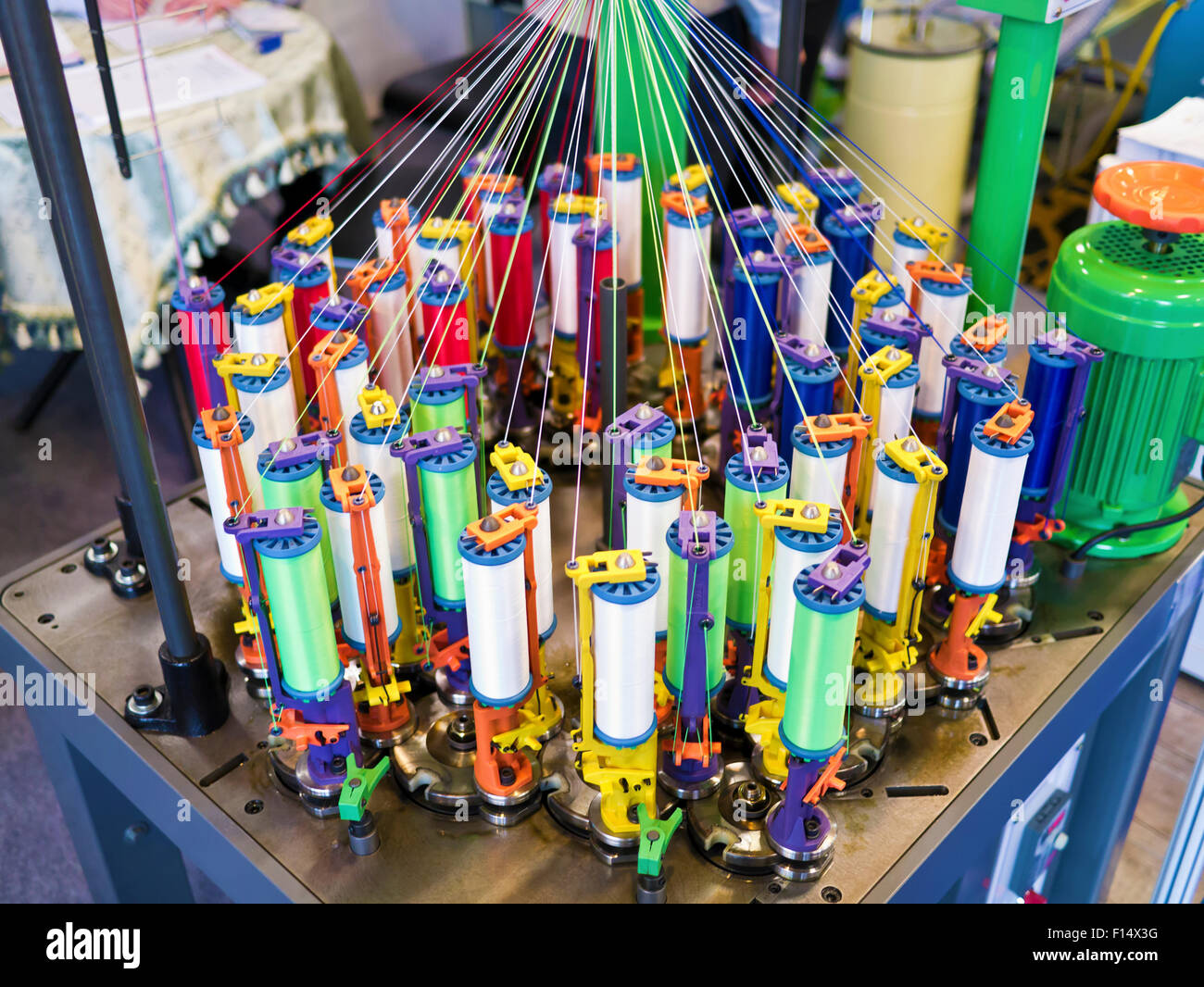 Textile industry - yarn spools on spinning machine in a textile factory Stock Photo