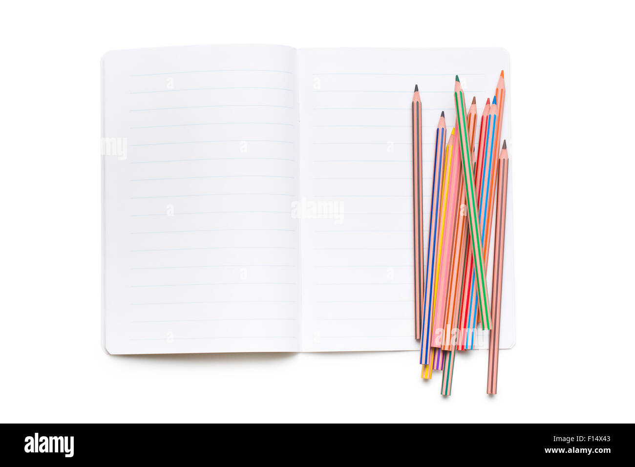 colored pencils and open workbook on white background Stock Photo