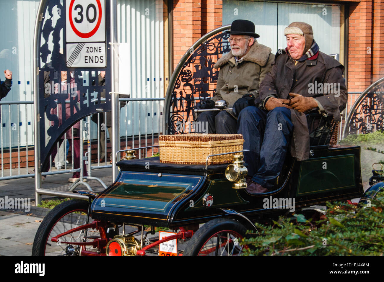 Drivers pass through Crawley in a vintage vehicle during the London to Brighton Veteran Car Run Stock Photo