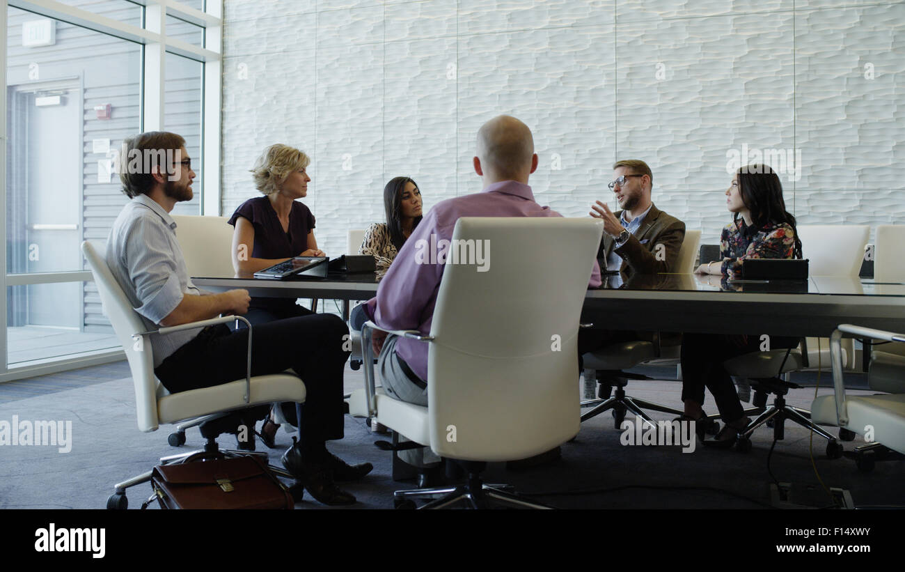Businessmen and businesswomen talking and working together in conference room meeting Stock Photo
