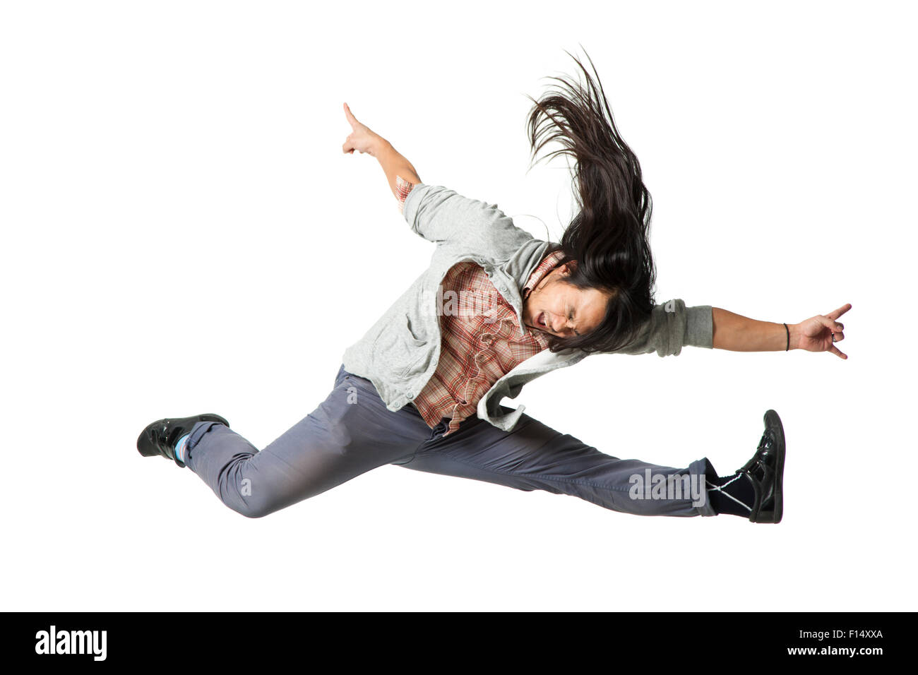 Man jumping in air with arms outstretched Stock Photo