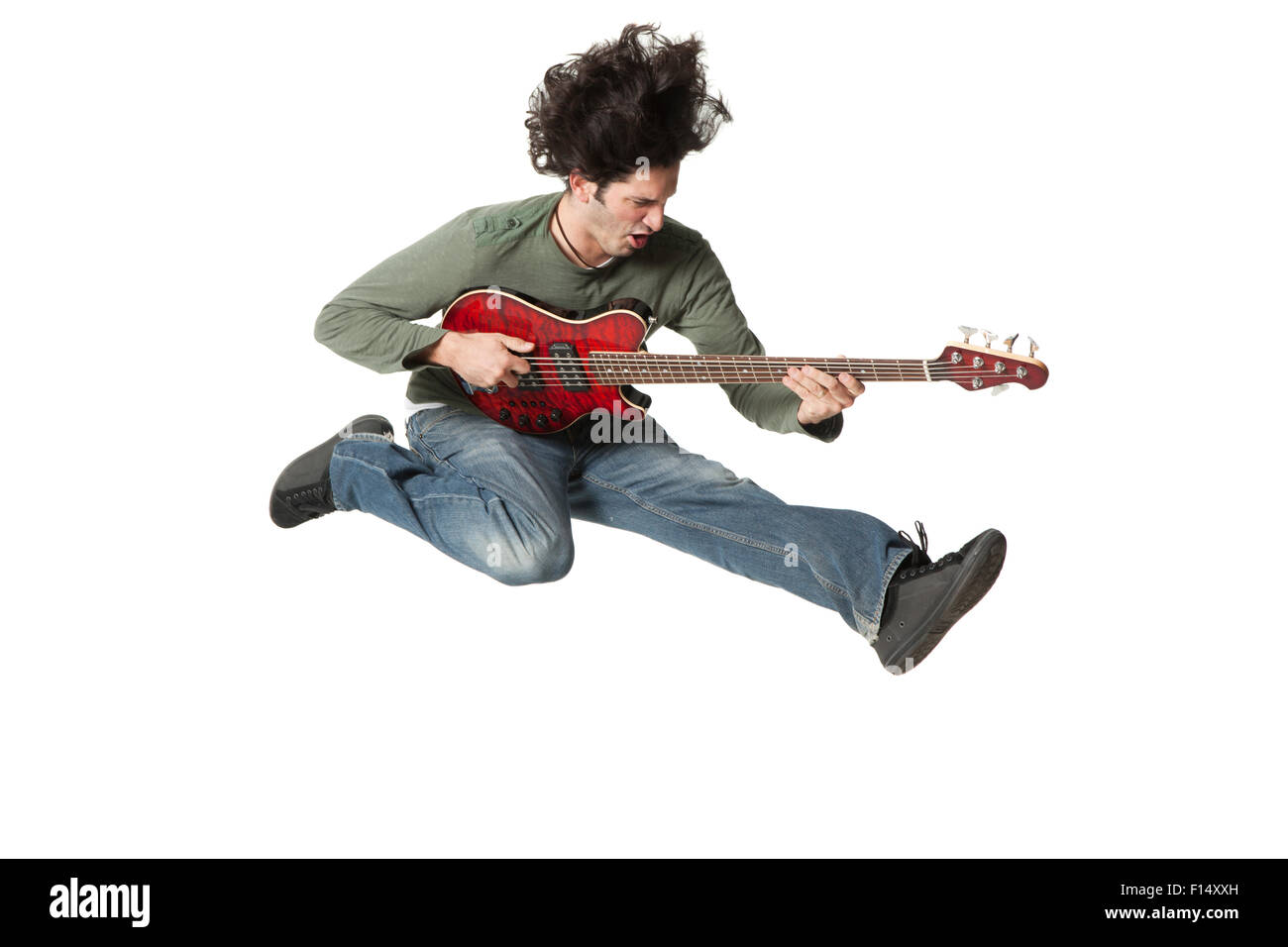 Man jumping in mid-air playing electric guitar Stock Photo
