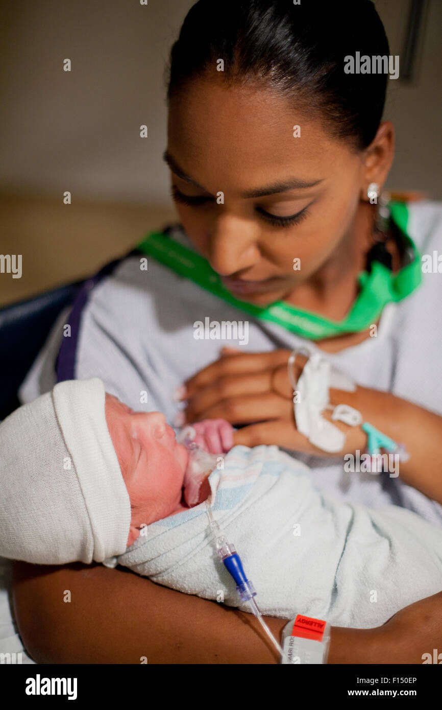 Mother holding newborn baby in hospital Stock Photo