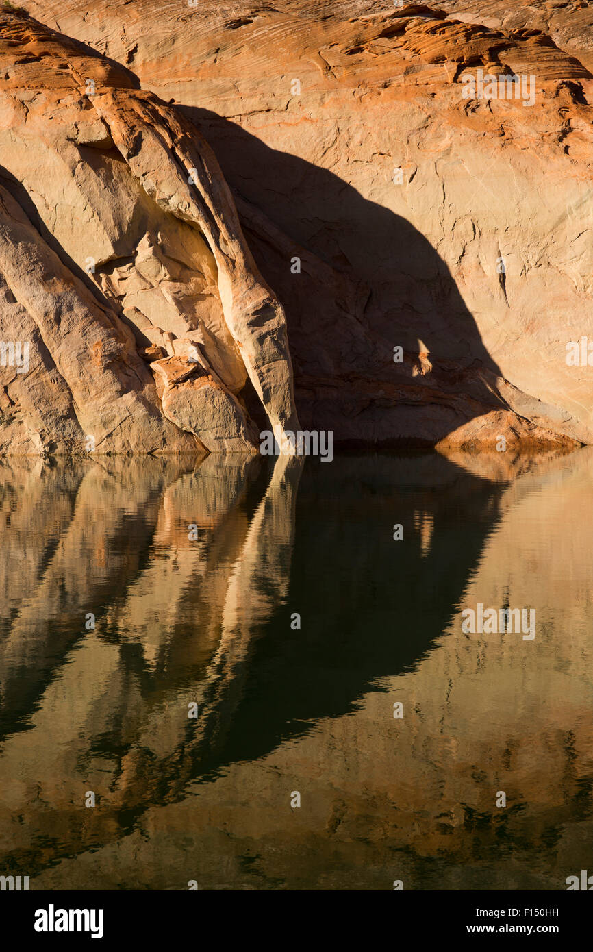 Rock formation and shadow reflecting in rippling still lake water Stock Photo