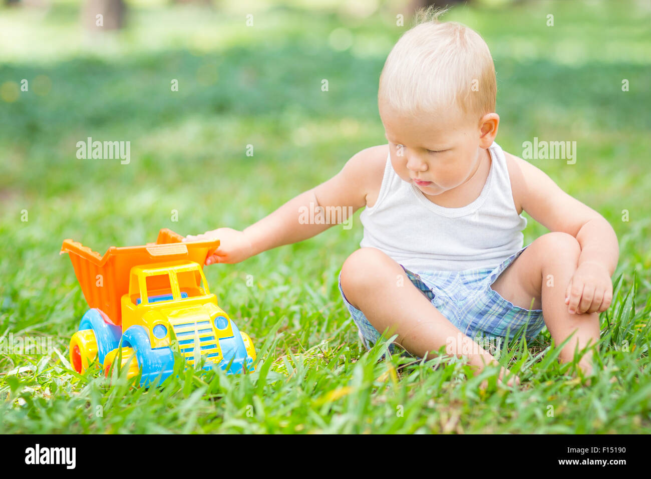 Little boy is playing toy car Stock Photo - Alamy
