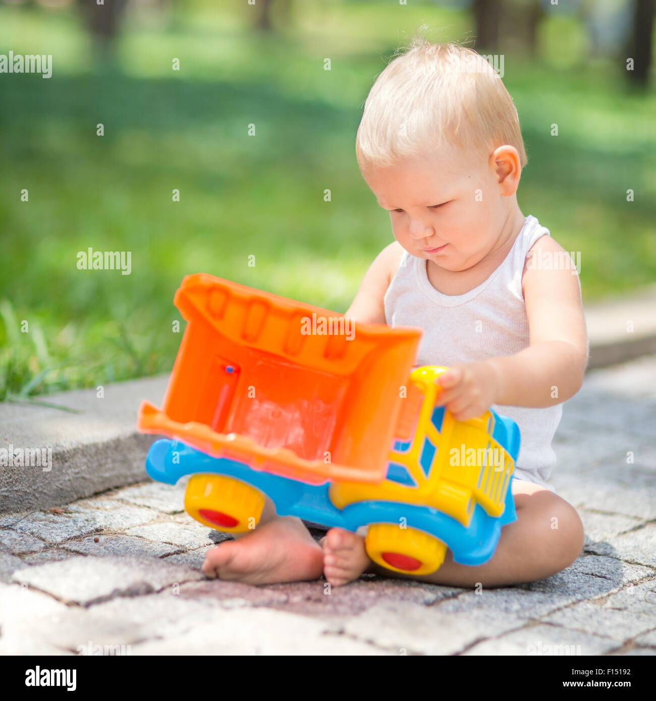 Little boy is playing toy car Stock Photo - Alamy