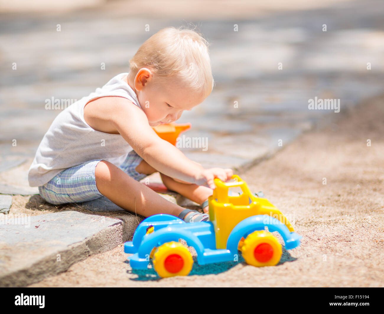 Little boy is playing toy car Stock Photo - Alamy