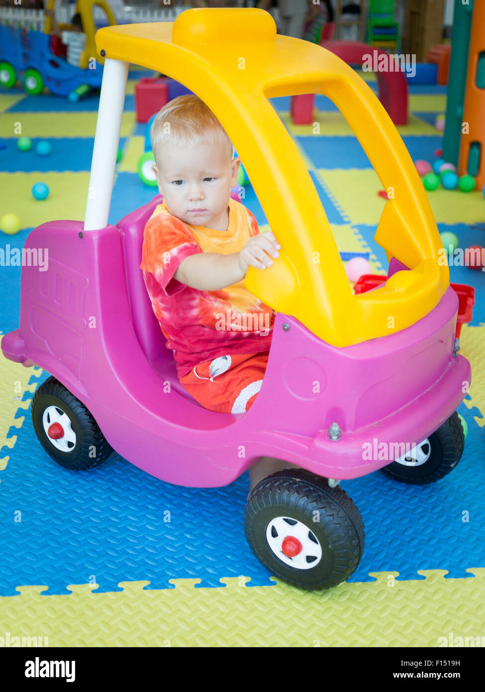 Cute kid boy playing with car Stock Photo