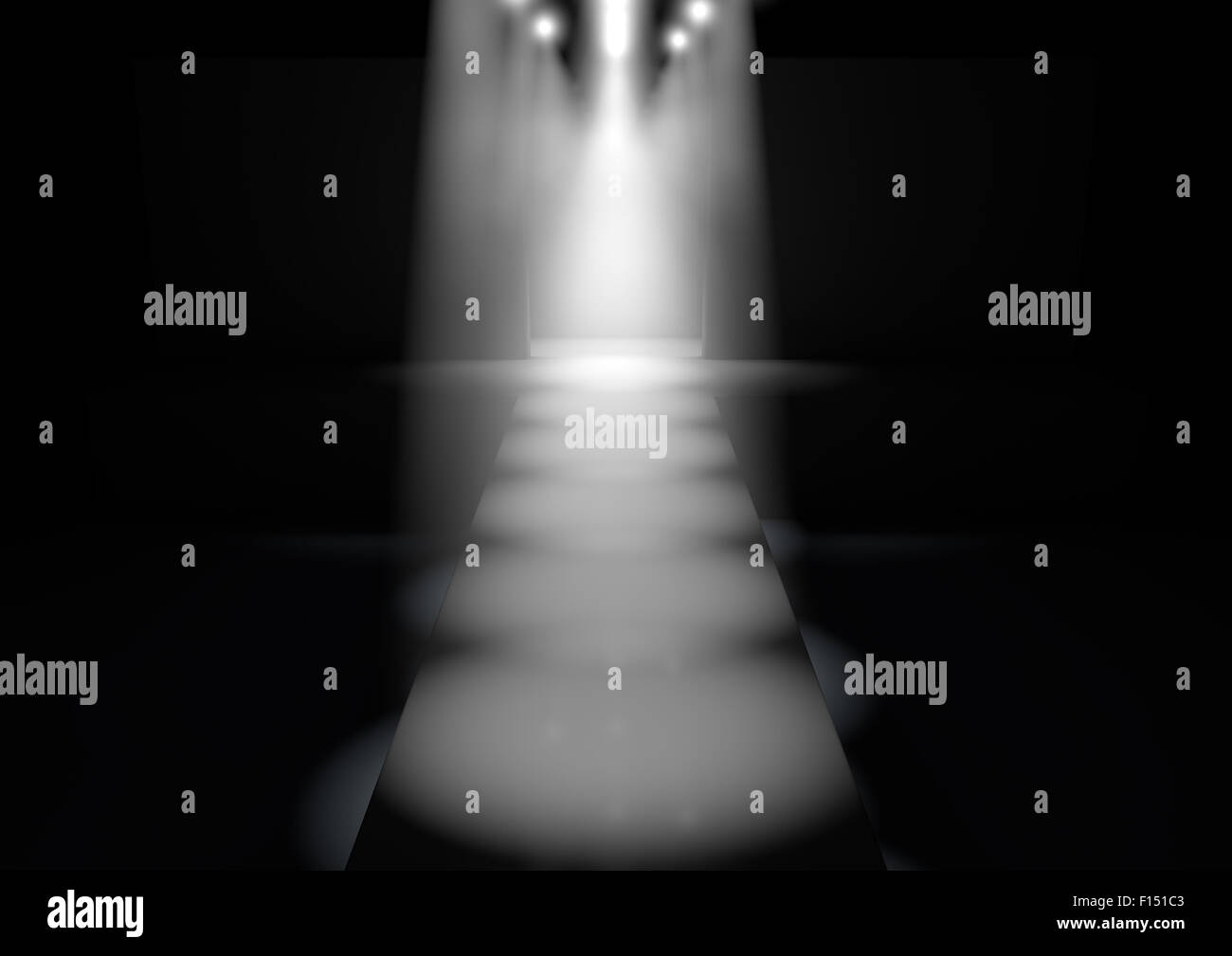 A fashion runway stage lit by a row of spotlights on a dark background