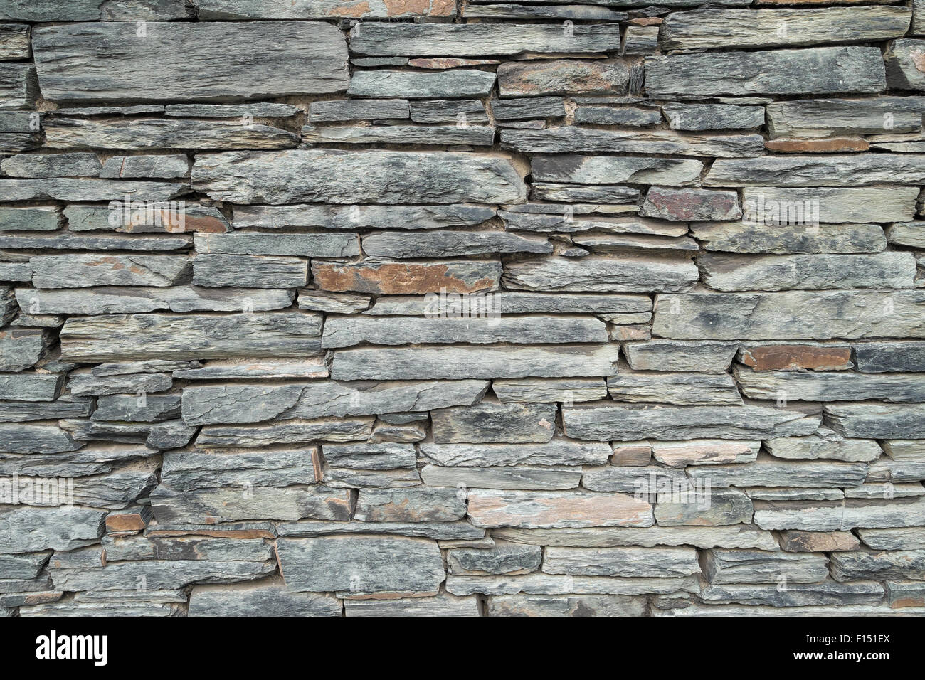 Background texture of a decorative slate stone wall. Stock Photo