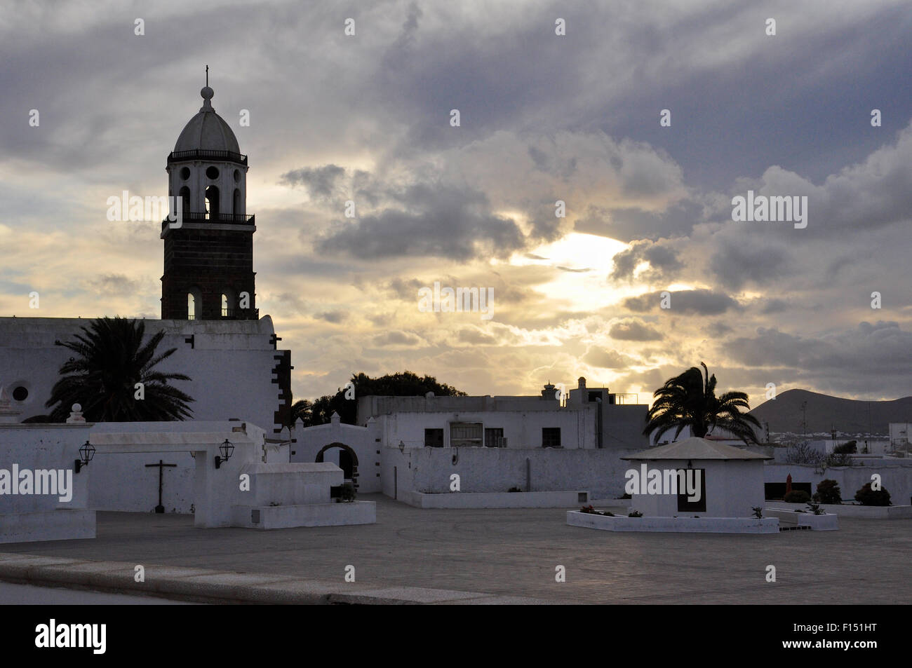 Sunset at Plaza de la Constitución of Teguise with bell tower of Nuestra Señora de Guadalupe Church (Teguise, Lanzarote, Canary Islands, Spain) Stock Photo