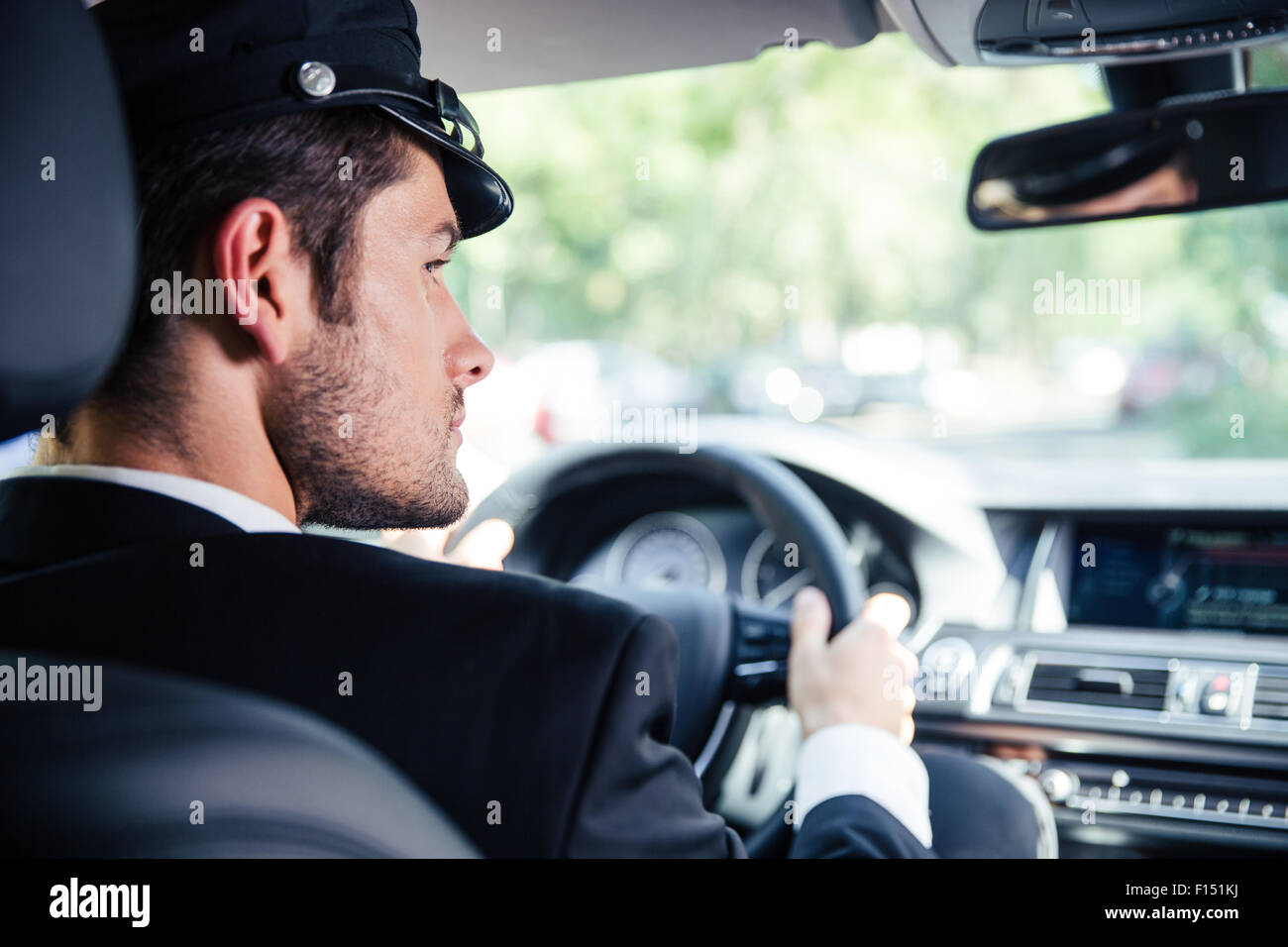 Portrait of a handsome male chauffeur riding car Stock Photo