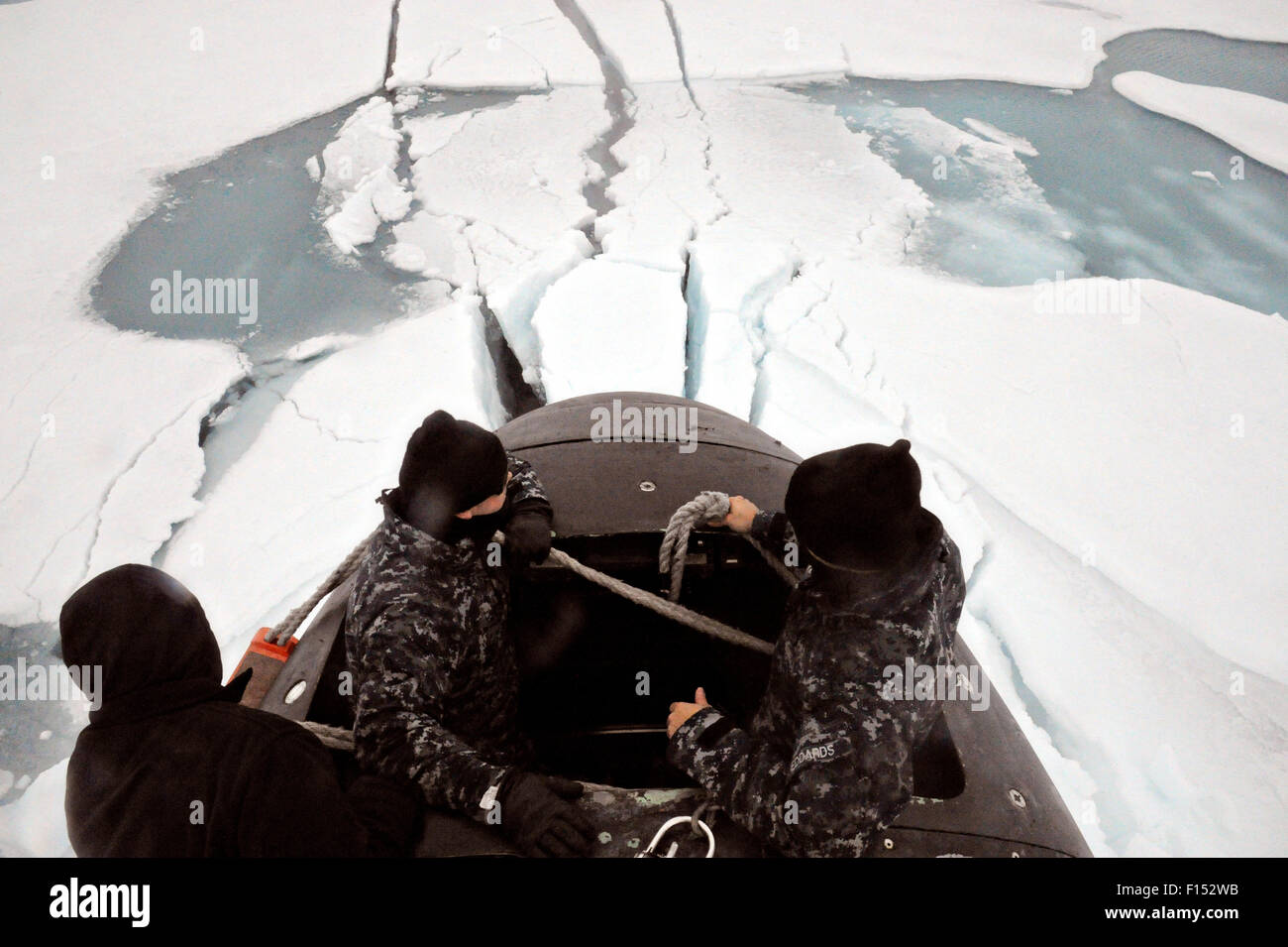 US Navy Sailors aboard the fast attack nuclear submarine USS Seawolf inspect the vessel as it surfaces through arctic ice in the North Pole August 1, 2015. Stock Photo