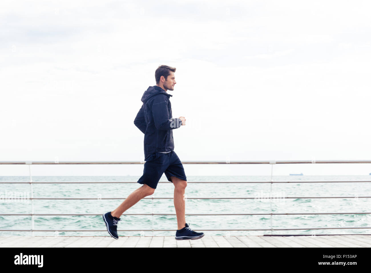 Man running into waves alone hi-res stock photography and images - Alamy