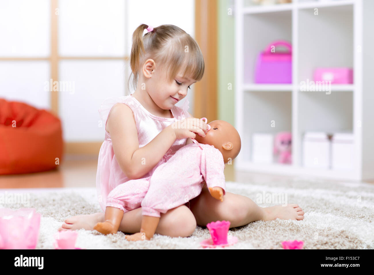 girl playing with her baby-doll Stock Photo