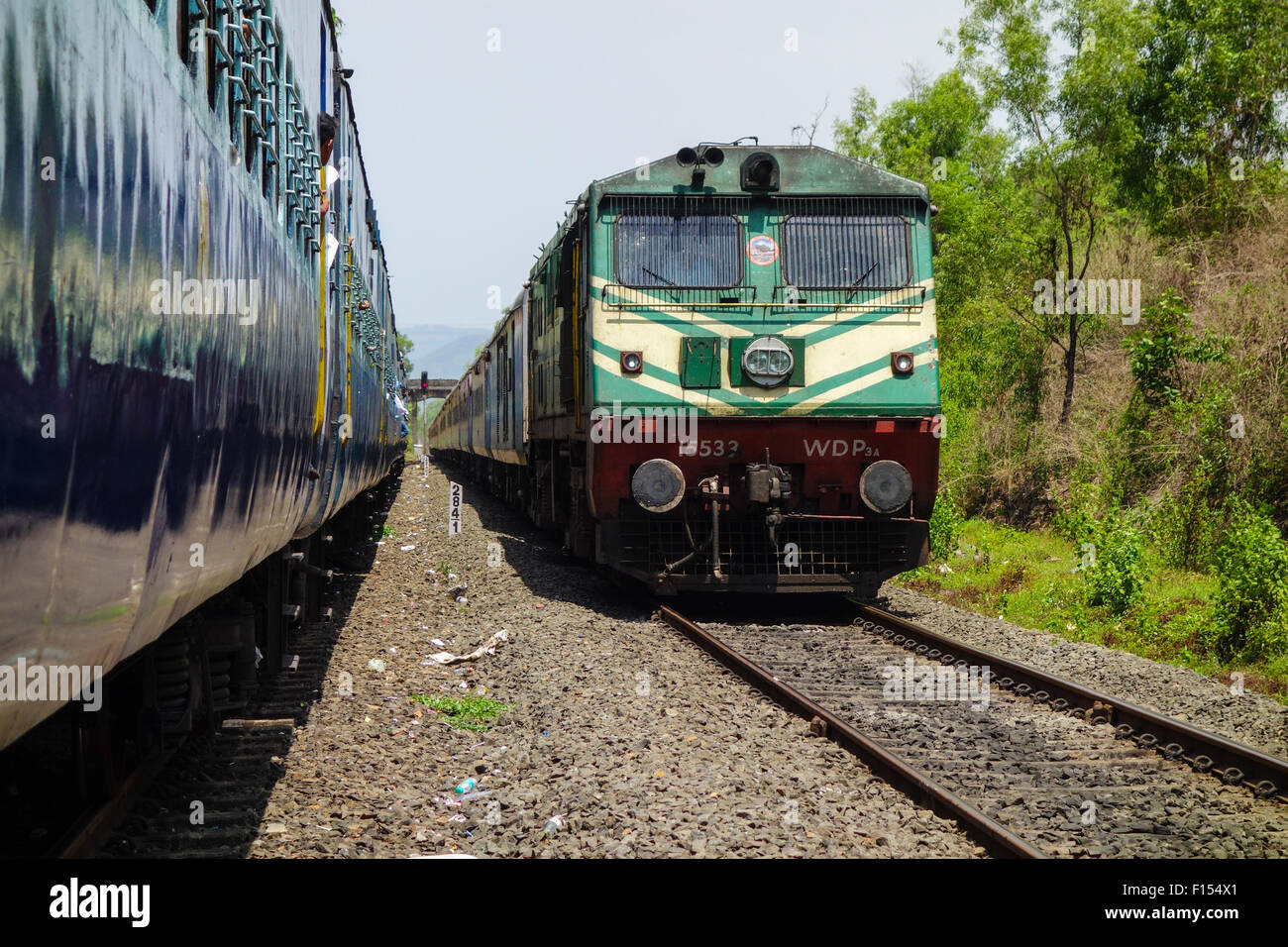 12431 Trivandrum - Hazrat Nizamuddin Rajdhani Express overtakes 10104 Mandovi Express at Vaibhavwadi Road on Konkan Railway. Stock Photo