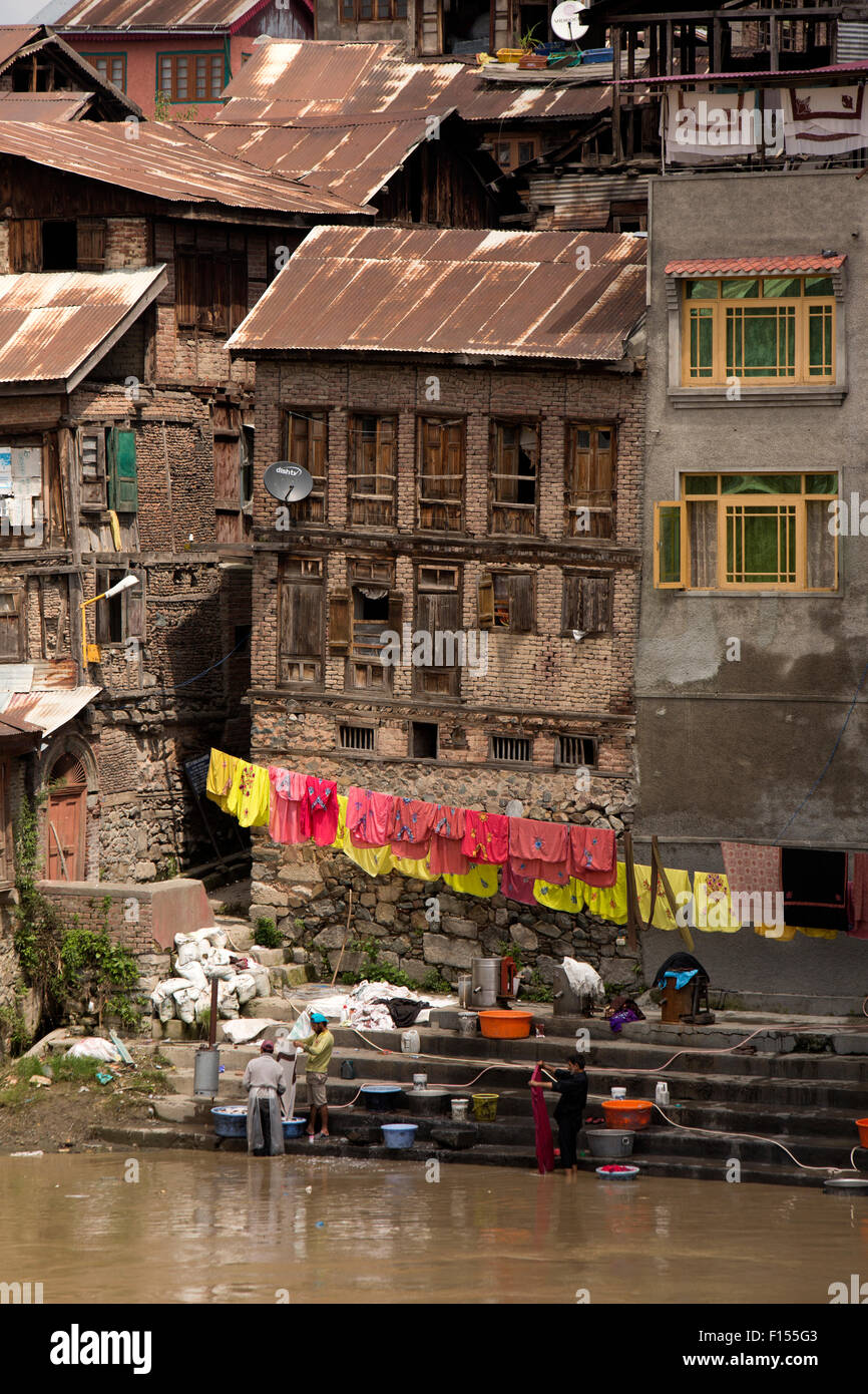 India, Jammu & Kashmir, Srinagar, old city, men washing textiles in River Jhelum on riverside ghat Stock Photo