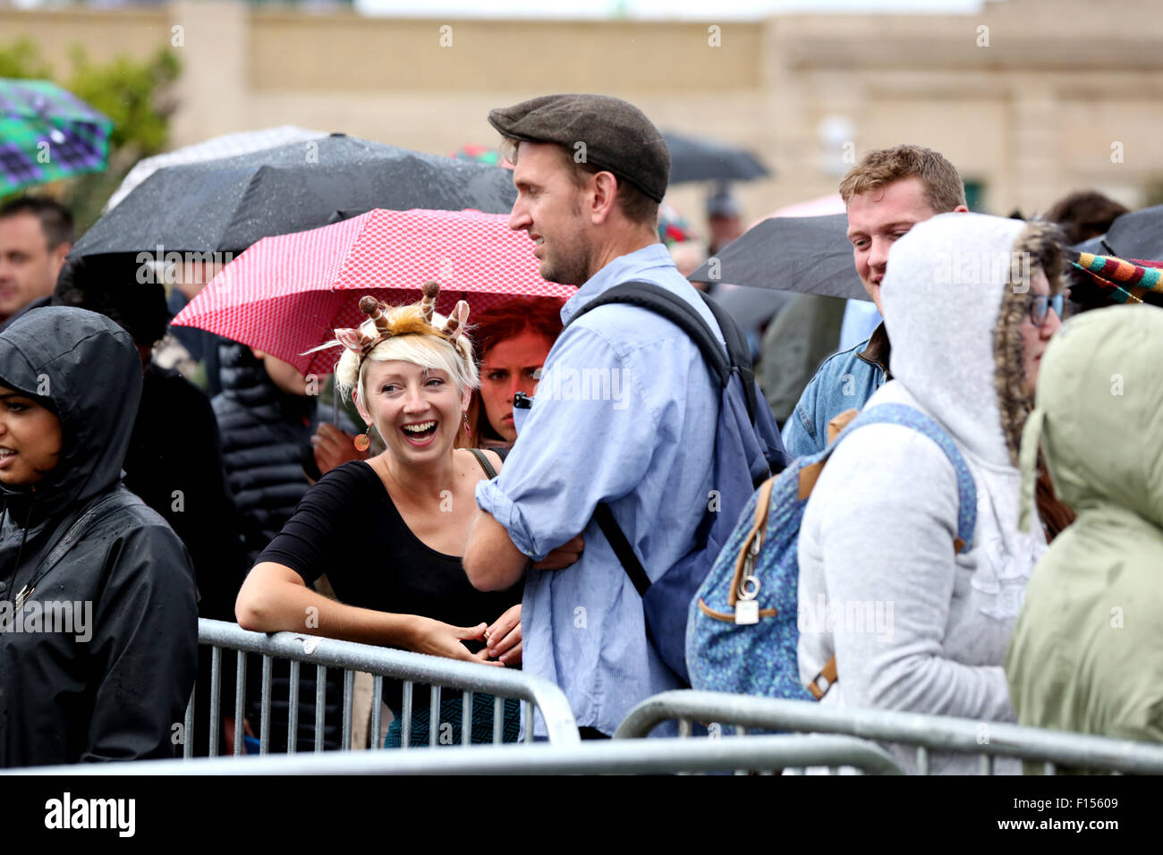 Weston-s-Mare, UK. 27th August 2015. People queuing for tickets for entry to the Banksy Dismaland Fun Park in Weston-s-Mare remain in high spirits. Despite the rain and just being told there were no more places available. Local Royalist Terry Hutt made his way around the crowds keeping them entertained. Credit:  Stephen Hyde/Alamy Live News Stock Photo