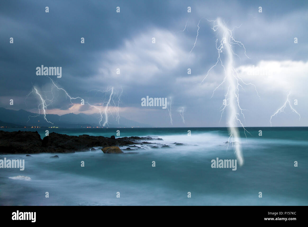 Lightning flashes across the beach from a powerful storm Stock Photo