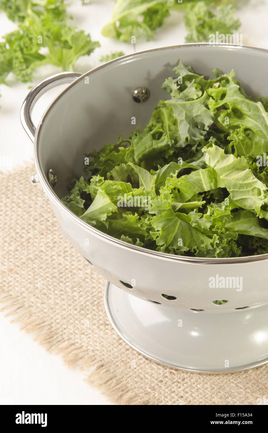 curly kale in a colander on jute Stock Photo