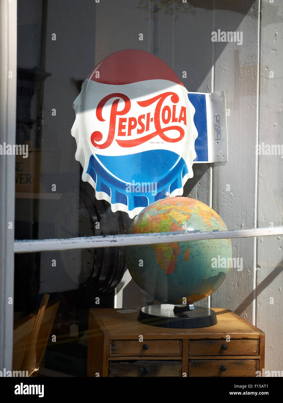 Pepsi-cola sign with world globe on display in antique shop UK Stock Photo