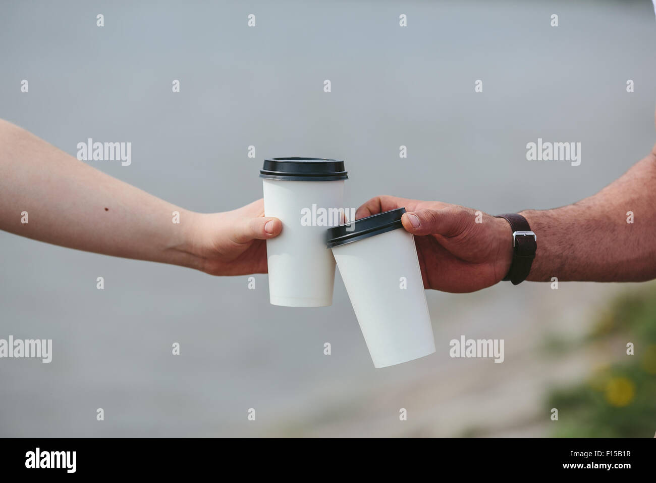 cheers using two cups of coffee Stock Photo Alamy