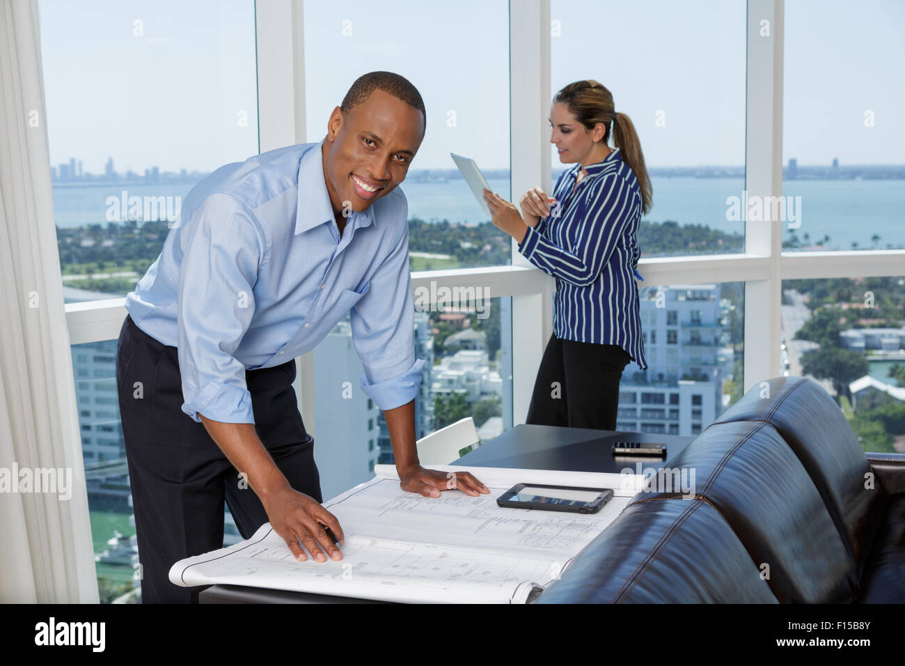 Happy male architect working with his female colleague using digital tablet Stock Photo