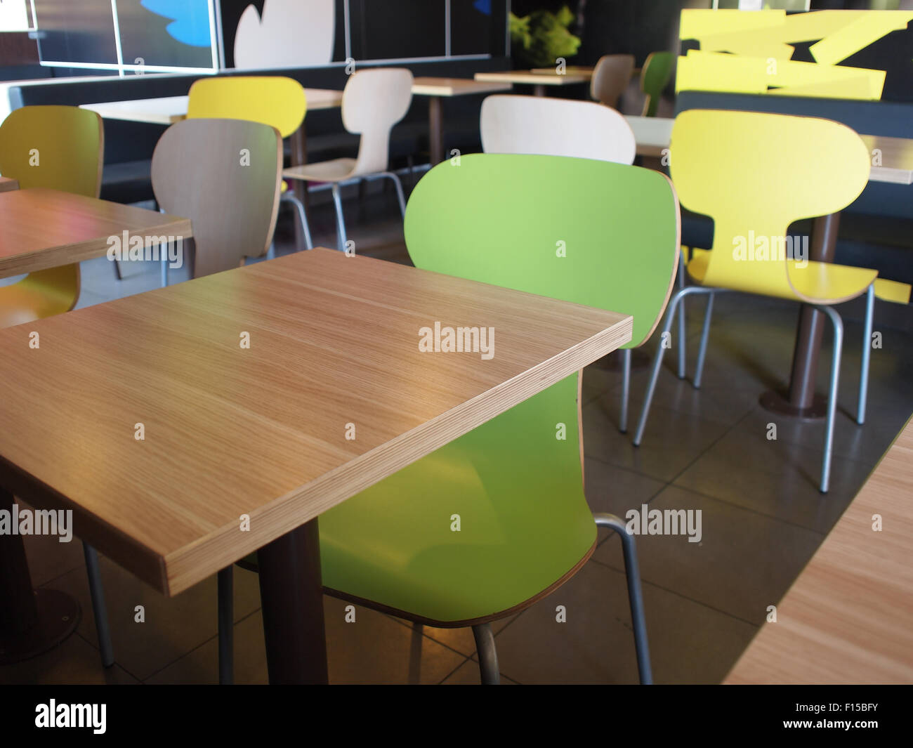 Empty tables and chairs in cafes without visitors, photographed with shallow depth of focus