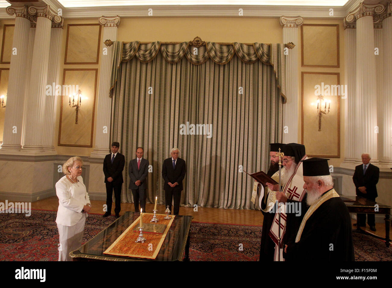 (150827) -- ATHENS, Aug. 27, 2015 (Xinhua) -- Vassiliki Thanou(L) takes an oath during a swearing in ceremony at the Presidential Palace in Athens, Greece, on Aug. 27, 2015. Greece's Supreme Court chief judge Vassiliki Thanou was appointed on Thursday to head the transitional government that will lead Greece to snap general elections in September, becoming the country's first female prime minister.  (Xinhua/Marios Lolos) Stock Photo