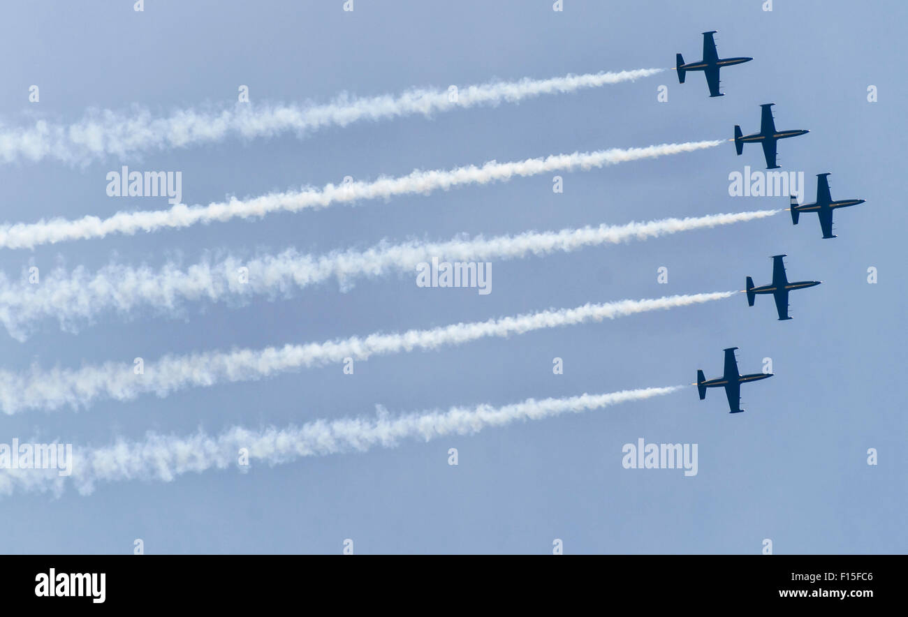 Five acrobatic aircraft flying in the sky with smoke behind Stock Photo