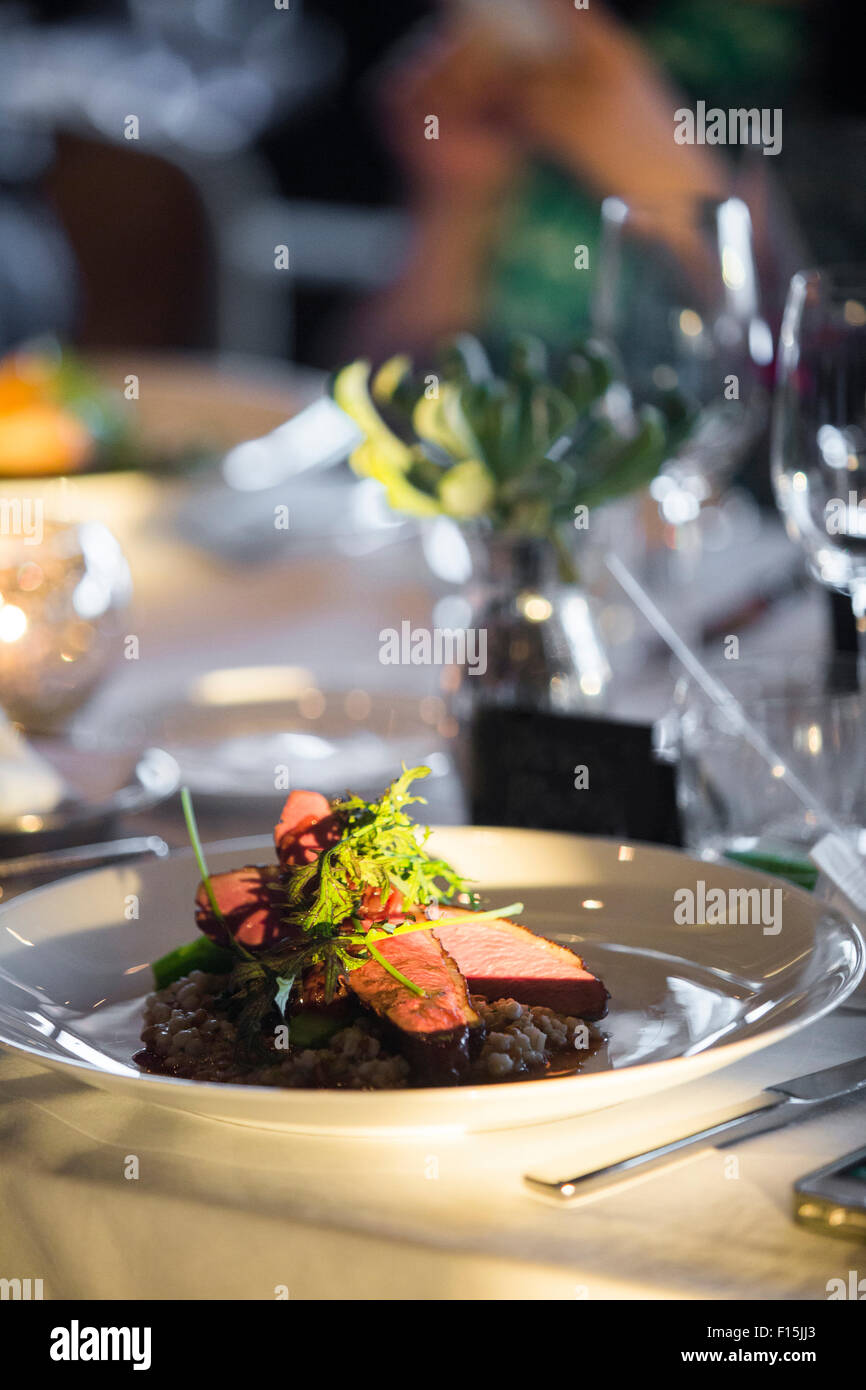 Beef with Arugula and Asparagus on Barley at Wedding Reception Stock Photo