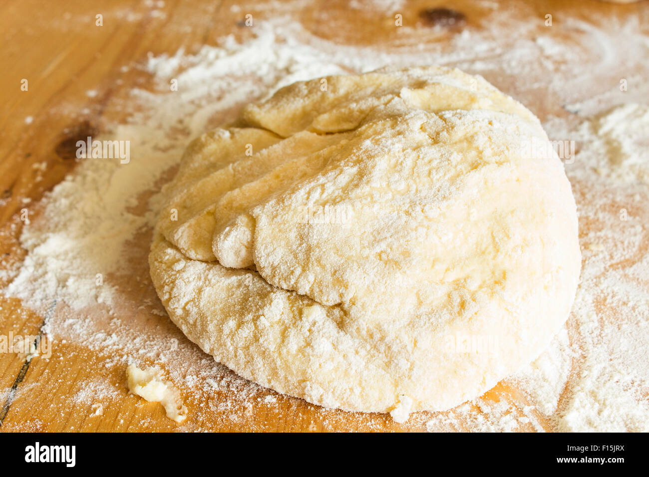The dough made of flour and potatoes, on the plank table Stock Photo