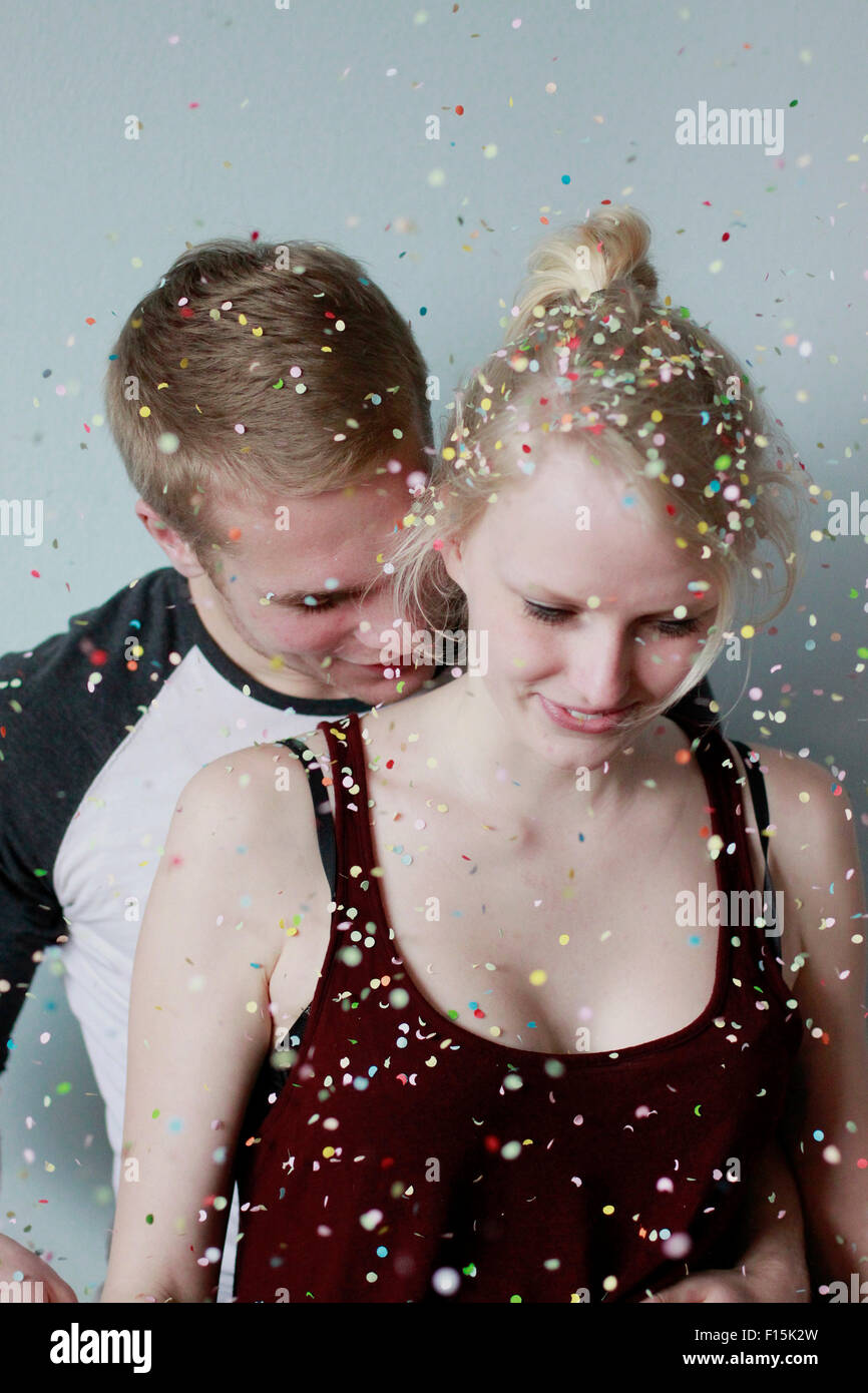 Couple kissing under confetti shower Stock Photo Alamy