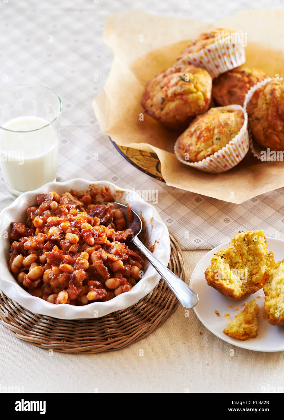 Baked beans and cornbread muffins with a glass of milk, studio shot Stock Photo