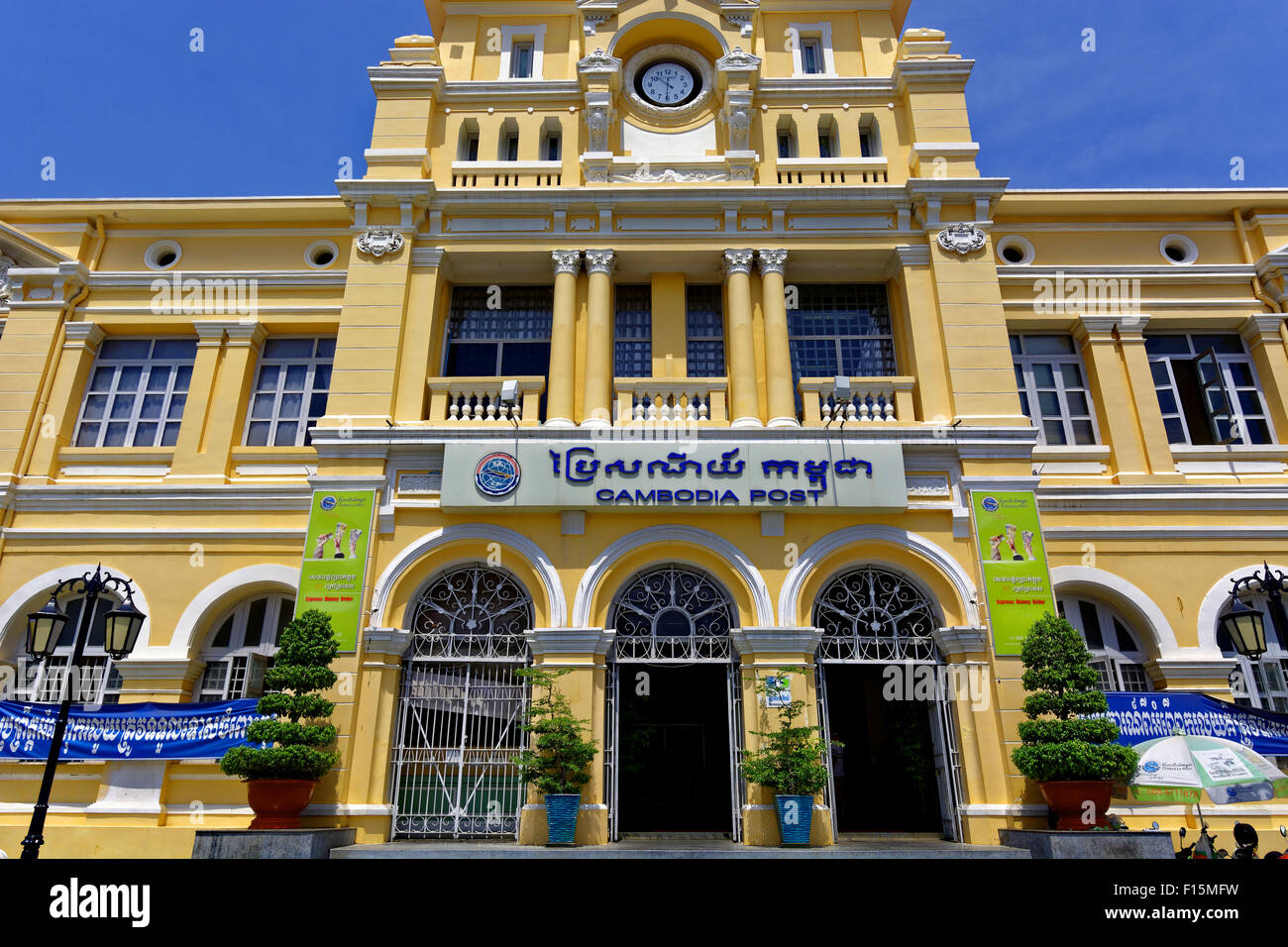 Cambodia Head Post Office, Phnom Penh, Cambodia, Khmer, Clock, Blue sky, bushes, stamps, money, posting, postmen, ornate buildin Stock Photo