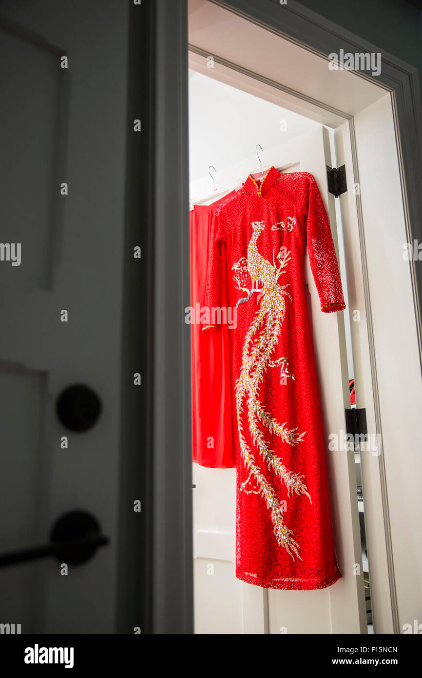 Red, cheongsam dress hanging on door at entrance to a room, Canada Stock  Photo - Alamy