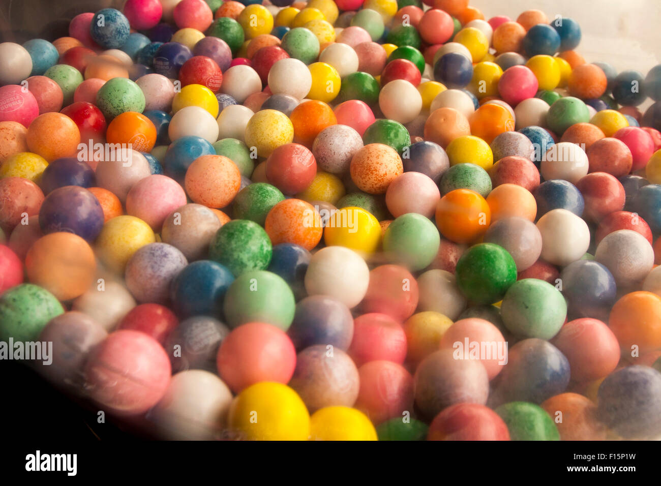 Multi-colored gumballs in a gumball machine on Mission Street, in The Mission, San Francisco, California. Stock Photo