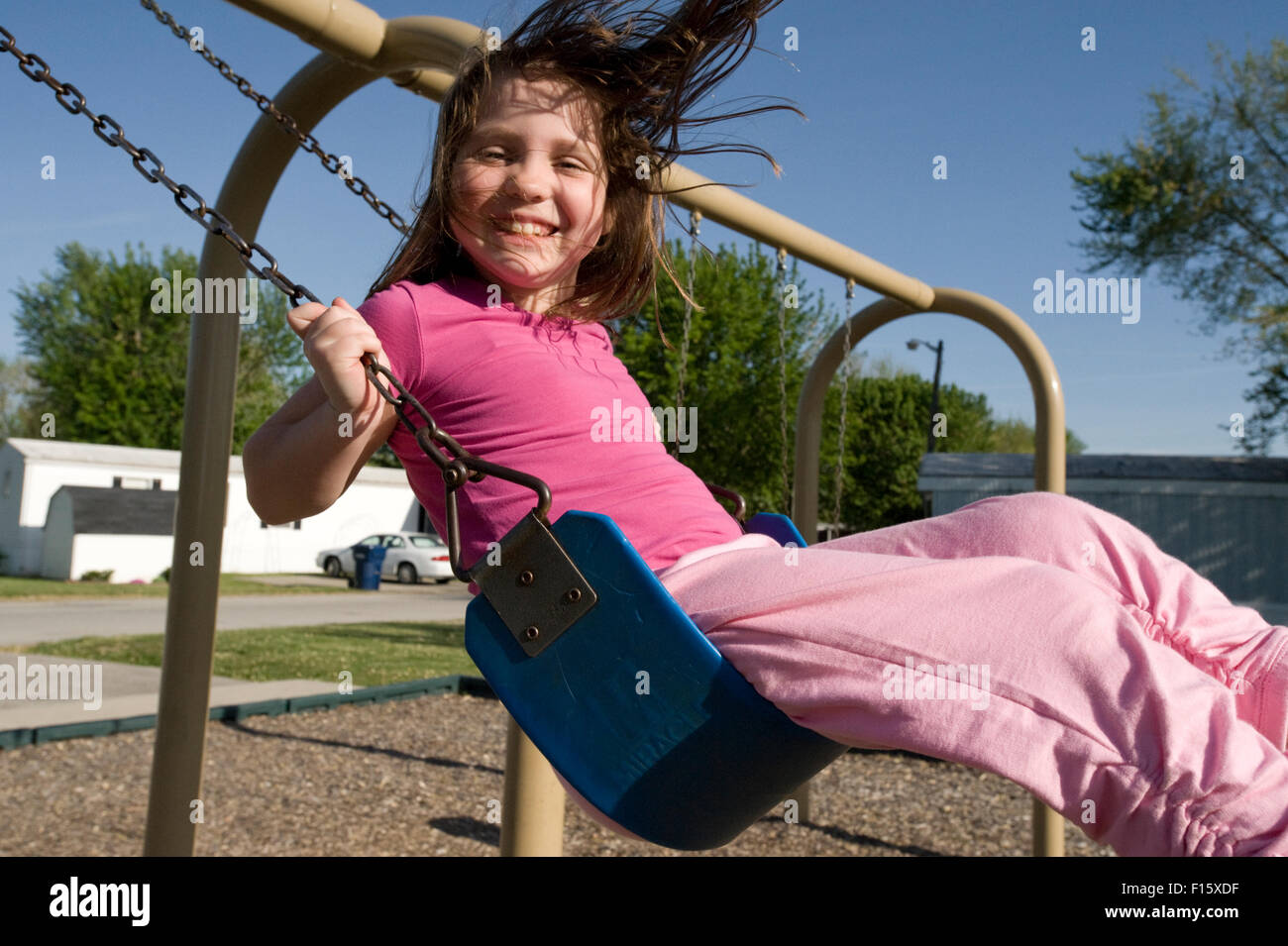 Young girl on swingset Stock Photo Alamy