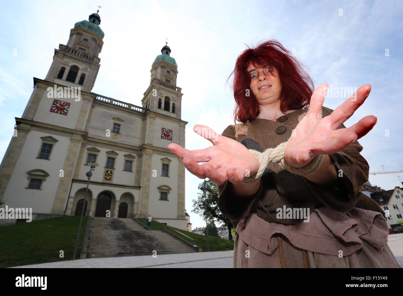 Kempten, Germany. 24th July, 2015. Actress Gabi Scheidl, dressed as a  witch, stands in front of the St. Lorenz Basilica in Kempten, Germany, 24  July 2015. Germany's last witch trial took place